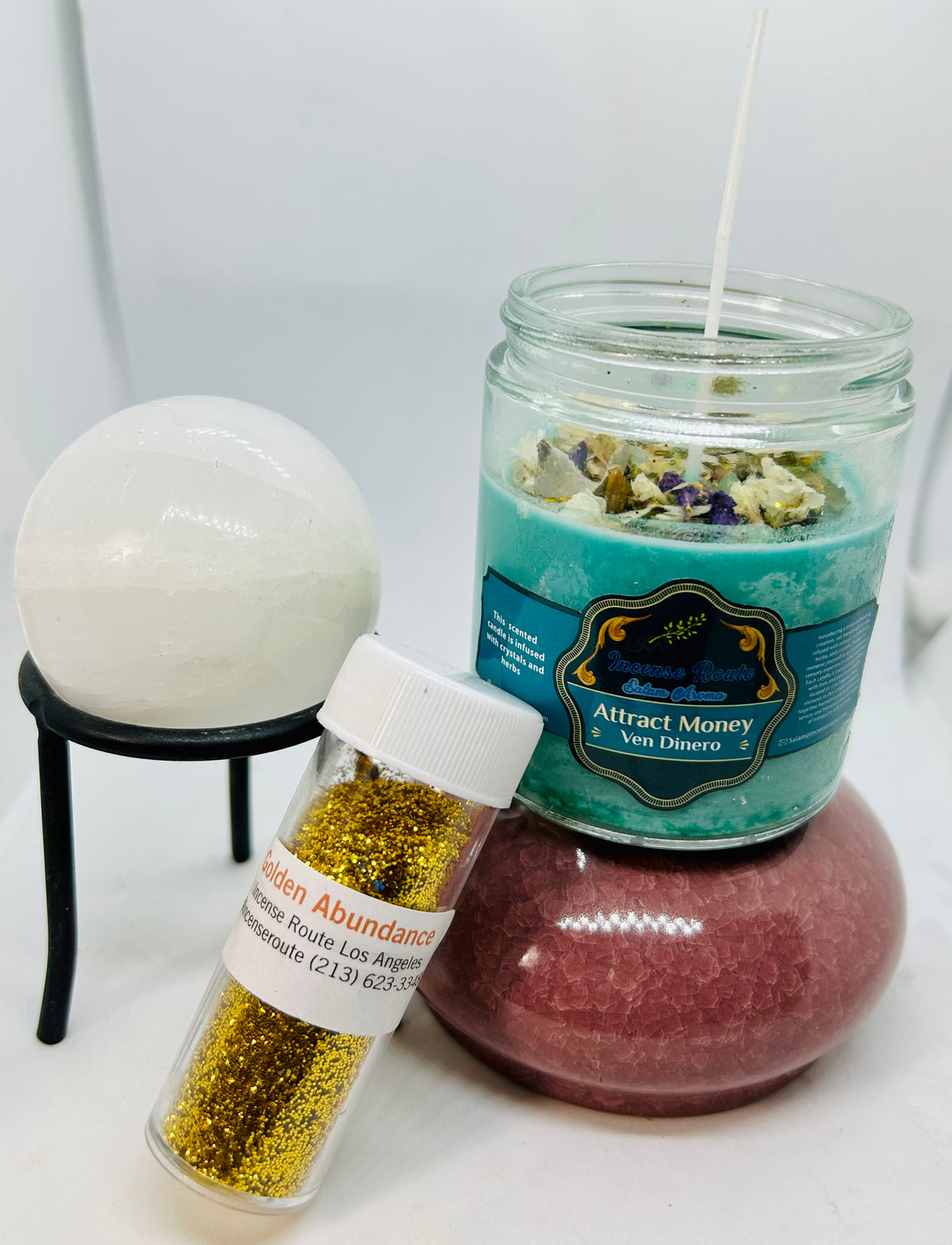 Green handmade candle with decorative herbs and crystals