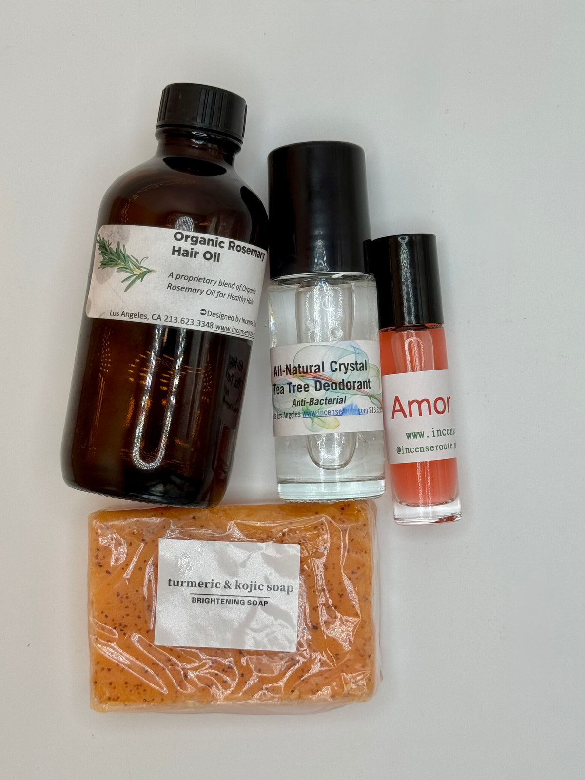 Self-Love Bundle with rosemary hair oil, alum deodorant, brightening soap, and Amor Amor roll-on